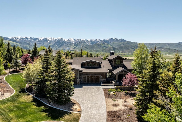 5925 Mountain Ranch Dr, Park City, UT 84098 - view of front of house with stone siding, a mountain view, driveway, and a chimney