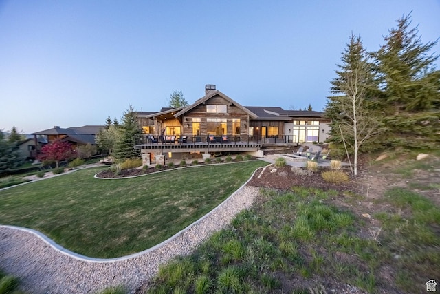 5925 Mountain Ranch Dr, Park City, UT 84098 - back of property featuring a chimney, a yard, stone siding, and a deck