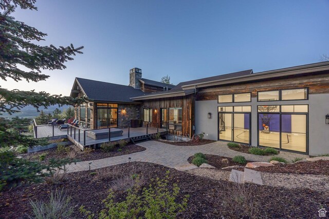5925 Mountain Ranch Dr, Park City, UT 84098 - back of property at dusk with a chimney and a deck