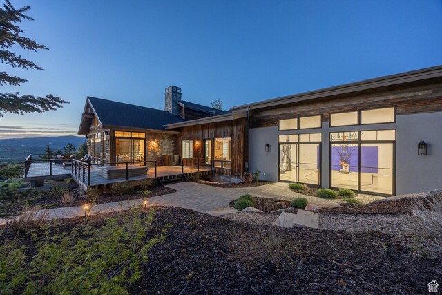 5925 Mountain Ranch Dr, Park City, UT 84098 - back of property with a chimney and a wooden deck