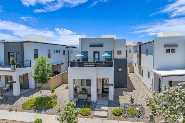 758 W Slate Ln, St George, UT 84790 - modern home featuring stucco siding, a balcony, and a residential view