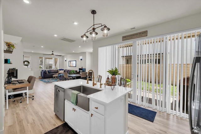 758 W Slate Ln, St George, UT 84790 - kitchen featuring stainless steel dishwasher, a sink, light wood-style floors, an island with sink, and recessed lighting