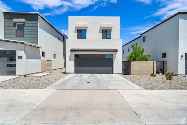758 W Slate Ln, St George, UT 84790 - contemporary home with concrete driveway, an attached garage, stucco siding, and a gate