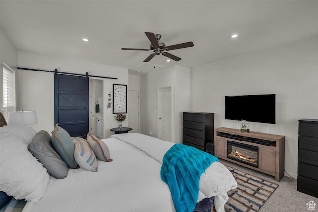 758 W Slate Ln, St George, UT 84790 - bedroom featuring a barn door, carpet flooring, recessed lighting, ceiling fan, and a glass covered fireplace