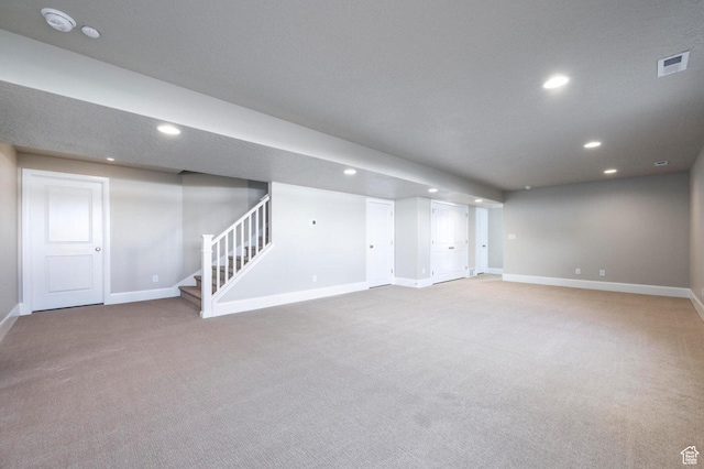 1460 Rocky Mountain Way Unit 223, Francis, UT 84036 - finished below grade area with carpet floors, baseboards, recessed lighting, and stairway