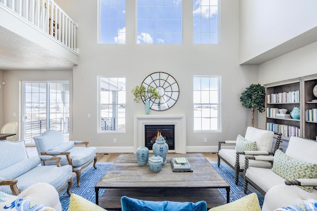 1460 Rocky Mountain Way Unit 223, Francis, UT 84036 - living area with a high ceiling, baseboards, wood finished floors, and a glass covered fireplace