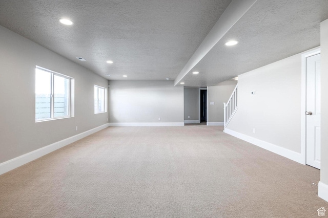 1460 Rocky Mountain Way Unit 223, Francis, UT 84036 - basement featuring a textured ceiling, recessed lighting, stairs, light carpet, and baseboards
