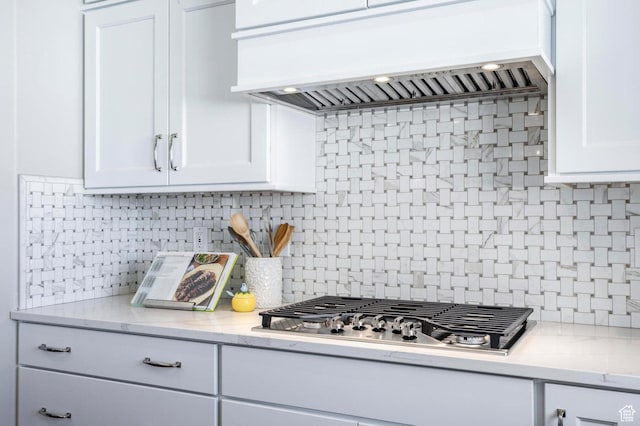 1460 Rocky Mountain Way Unit 223, Francis, UT 84036 - kitchen featuring stainless steel gas cooktop, custom range hood, tasteful backsplash, and white cabinetry