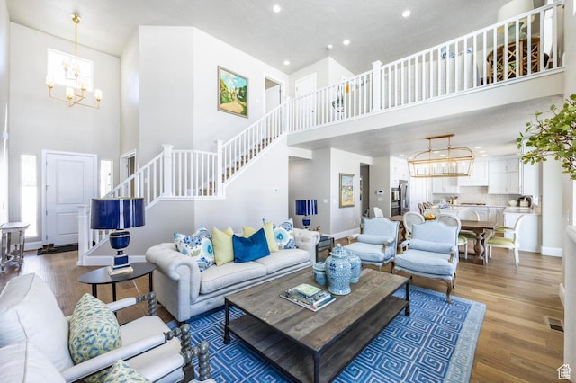1460 Rocky Mountain Way Unit 223, Francis, UT 84036 - living area with a chandelier, a high ceiling, stairway, baseboards, and plenty of natural light