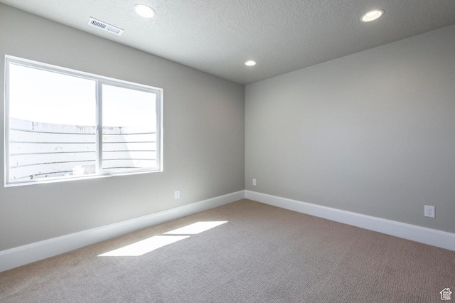 1460 Rocky Mountain Way Unit 223, Francis, UT 84036 - carpeted spare room featuring recessed lighting, a textured ceiling, and baseboards
