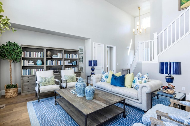 1460 Rocky Mountain Way Unit 223, Francis, UT 84036 - living area featuring a high ceiling, stairs, wood finished floors, and a chandelier