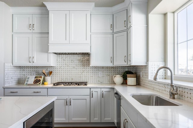 1460 Rocky Mountain Way Unit 223, Francis, UT 84036 - kitchen with a sink, stainless steel appliances, backsplash, light stone countertops, and wine cooler