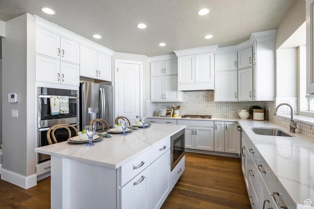 1460 Rocky Mountain Way Unit 223, Francis, UT 84036 - kitchen featuring stainless steel appliances, a sink, dark wood-style floors, white cabinetry, and tasteful backsplash