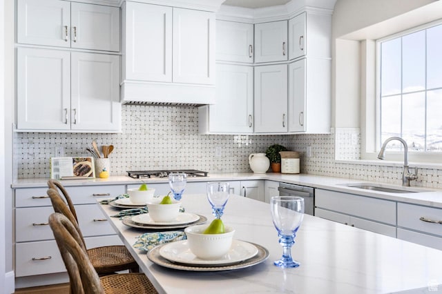 1460 Rocky Mountain Way Unit 223, Francis, UT 84036 - kitchen featuring a sink, a kitchen breakfast bar, decorative backsplash, white cabinetry, and stainless steel appliances
