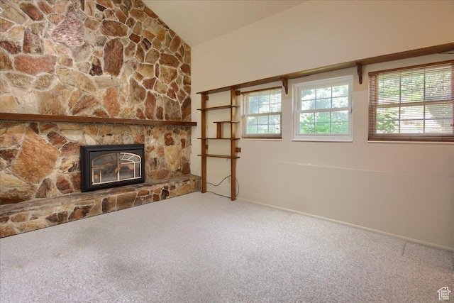 5725 S 1075 E, South Ogden, UT 84405 - unfurnished living room with carpet flooring, vaulted ceiling, a fireplace, and baseboards