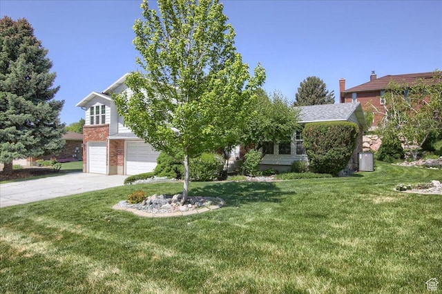 5725 S 1075 E, South Ogden, UT 84405 - obstructed view of property featuring driveway, a garage, a front yard, and brick siding