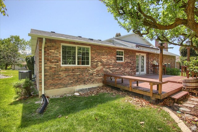 5725 S 1075 E, South Ogden, UT 84405 - rear view of house featuring brick siding, a yard, a wooden deck, and french doors