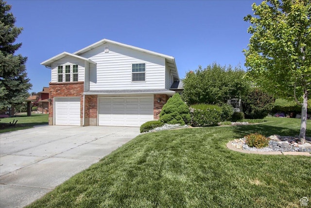 5725 S 1075 E, South Ogden, UT 84405 - view of front of home featuring brick siding, an attached garage, driveway, and a front lawn