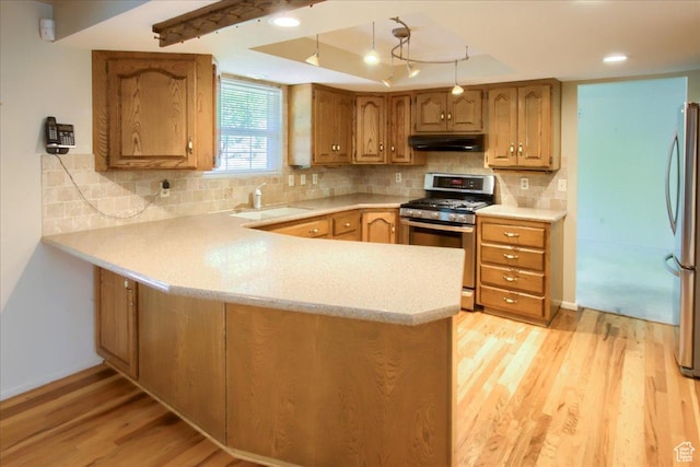 5725 S 1075 E, South Ogden, UT 84405 - kitchen with appliances with stainless steel finishes, under cabinet range hood, a sink, and light countertops