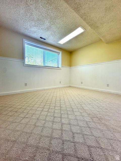558 E Center St, Kaysville, UT 84037 - unfurnished room featuring wainscoting, a textured ceiling, and carpet floors