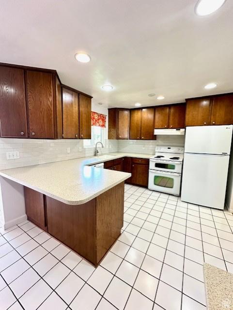 558 E Center St, Kaysville, UT 84037 - kitchen with white appliances, under cabinet range hood, a peninsula, light countertops, and a sink