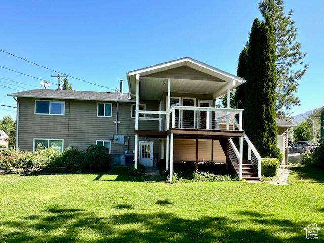 558 E Center St, Kaysville, UT 84037 - back of house with stairway, a yard, and a deck