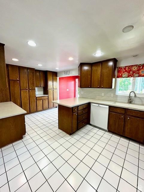 558 E Center St, Kaysville, UT 84037 - kitchen with dishwasher, a peninsula, a sink, light countertops, and decorative backsplash