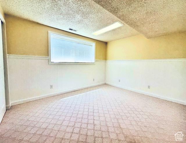 558 E Center St, Kaysville, UT 84037 - carpeted spare room featuring a wainscoted wall and a textured ceiling