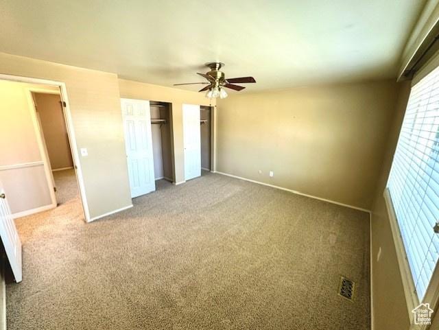 558 E Center St, Kaysville, UT 84037 - unfurnished bedroom featuring carpet, baseboards, ceiling fan, and multiple closets