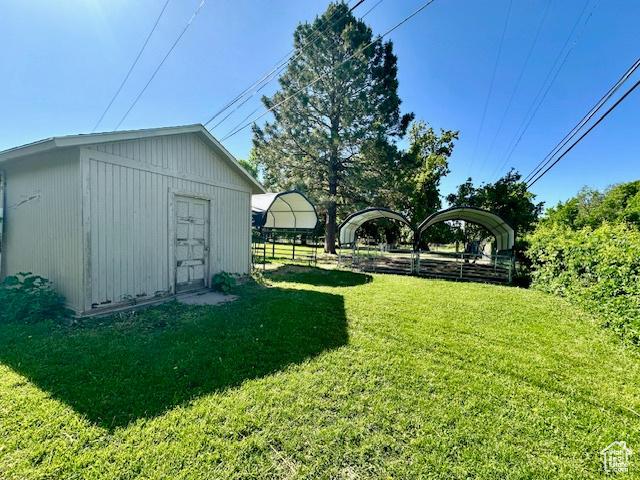 558 E Center St, Kaysville, UT 84037 - view of grassy yard featuring an outbuilding