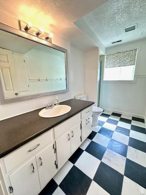 558 E Center St, Kaysville, UT 84037 - bathroom with tile patterned floors, vanity, toilet, a textured ceiling, and baseboards