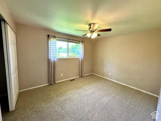 558 E Center St, Kaysville, UT 84037 - unfurnished bedroom featuring carpet flooring, baseboards, a ceiling fan, and a closet