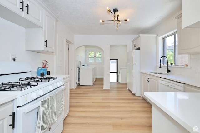 557 E Cleveland Ave, Salt Lake City, UT 84105 - kitchen with white appliances, washer / dryer, a sink, and plenty of natural light