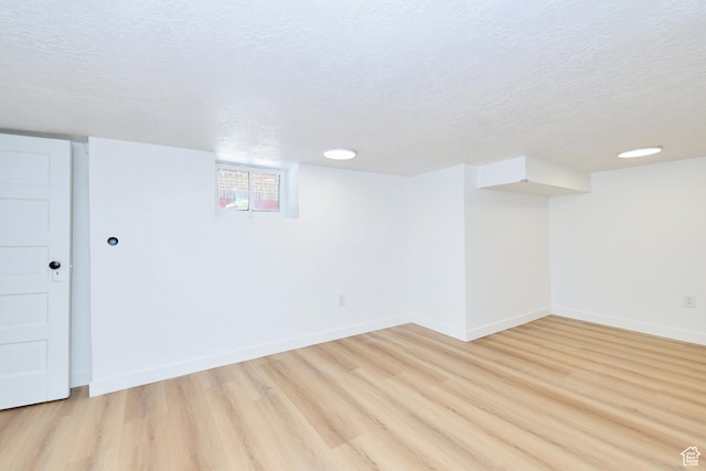 557 E Cleveland Ave, Salt Lake City, UT 84105 - basement with light wood-type flooring, baseboards, and a textured ceiling
