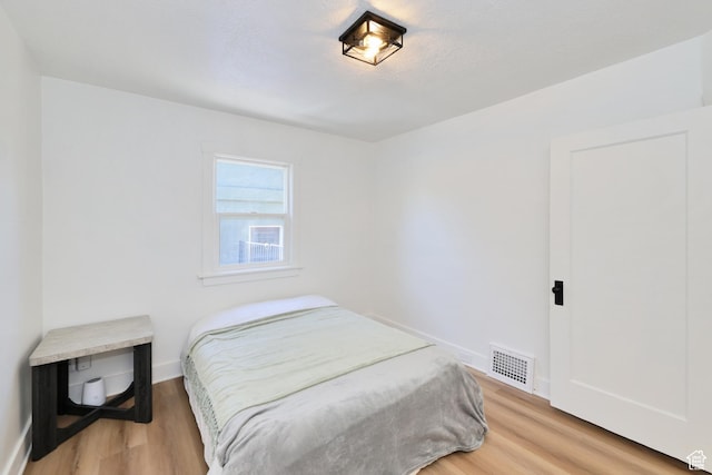 557 E Cleveland Ave, Salt Lake City, UT 84105 - bedroom with light wood-style flooring and baseboards