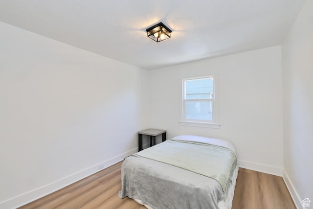 557 E Cleveland Ave, Salt Lake City, UT 84105 - bedroom with baseboards and light wood-style flooring