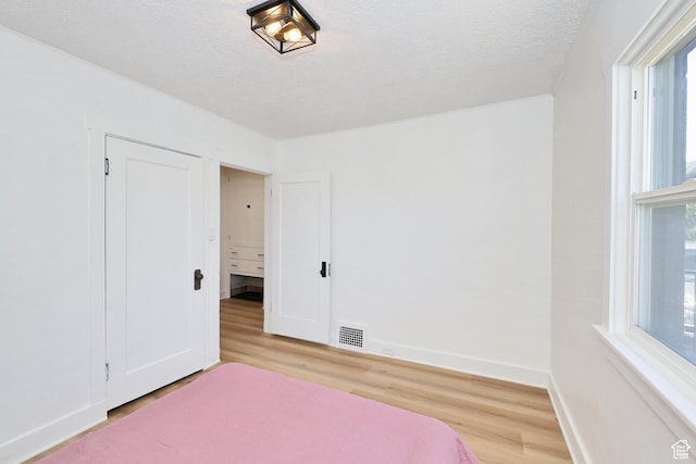 557 E Cleveland Ave, Salt Lake City, UT 84105 - bedroom featuring light wood-style flooring and baseboards