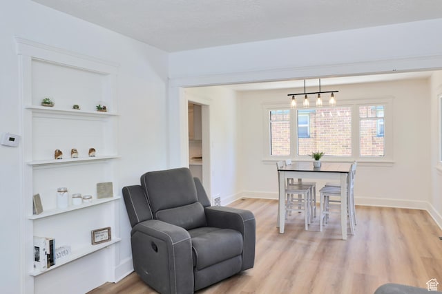557 E Cleveland Ave, Salt Lake City, UT 84105 - living area with light wood-style flooring and baseboards