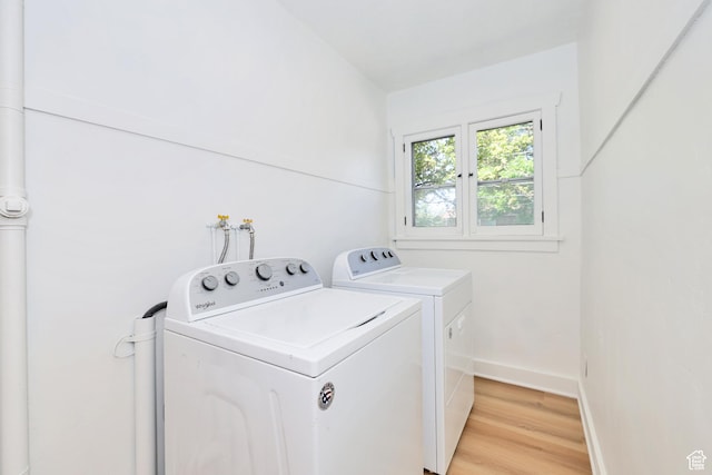 557 E Cleveland Ave, Salt Lake City, UT 84105 - laundry room featuring washer and dryer, light wood-type flooring, and baseboards