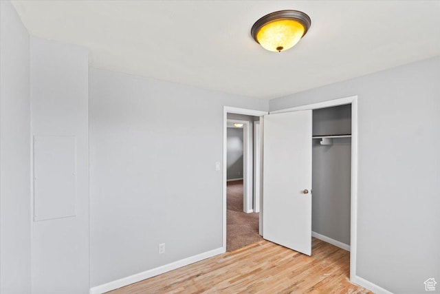 5824 S 2150 W, Roy, UT 84067 - unfurnished bedroom featuring wood finished floors, baseboards, and a closet