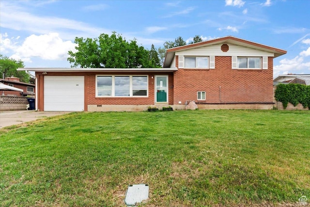 5824 S 2150 W, Roy, UT 84067 - split level home with a garage, concrete driveway, a front lawn, and brick siding