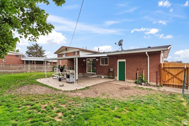 5824 S 2150 W, Roy, UT 84067 - back of house with a patio, brick siding, and a gate