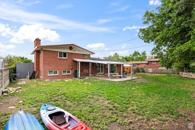 5824 S 2150 W, Roy, UT 84067 - rear view of house with brick siding, a chimney, and a patio area