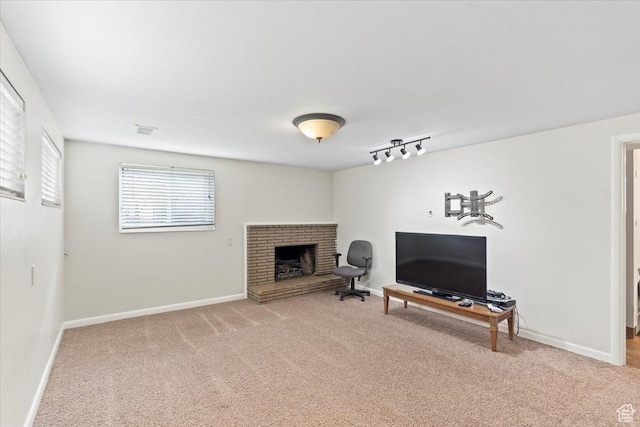 5824 S 2150 W, Roy, UT 84067 - living area with carpet flooring, baseboards, a fireplace, and track lighting