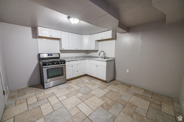 253 S 100 W, American Fork, UT 84003 - kitchen with stainless steel range with gas cooktop, a sink, tasteful backsplash, light stone counters, and stone tile floors