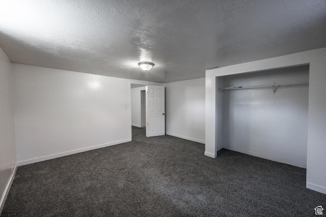 253 S 100 W, American Fork, UT 84003 - unfurnished bedroom featuring dark colored carpet, baseboards, a textured ceiling, and a closet