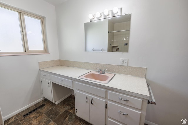253 S 100 W, American Fork, UT 84003 - bathroom with vanity, a tile shower, baseboards, and stone finish floors