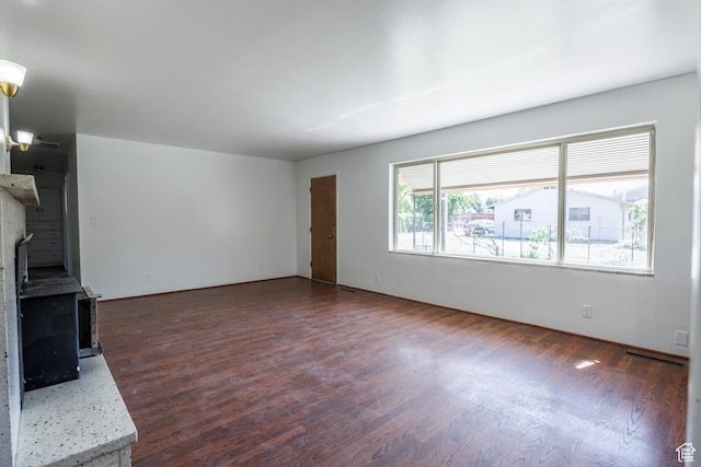 253 S 100 W, American Fork, UT 84003 - unfurnished living room with dark wood-type flooring and a wood stove
