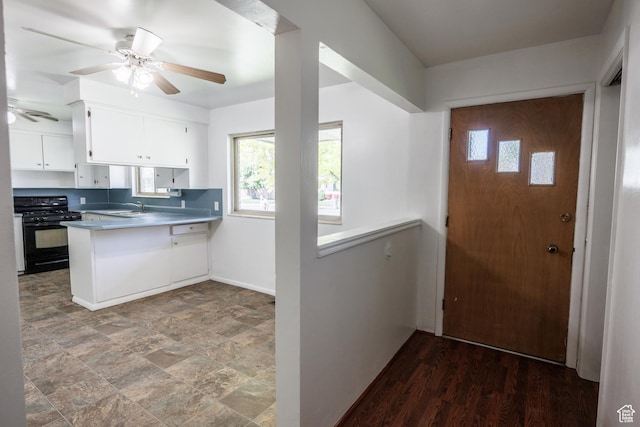 253 S 100 W, American Fork, UT 84003 - kitchen featuring gas stove, a sink, a ceiling fan, white cabinets, and a peninsula