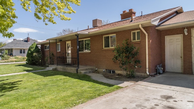 253 S 100 W, American Fork, UT 84003 - view of front facade featuring a chimney, a front lawn, and brick siding